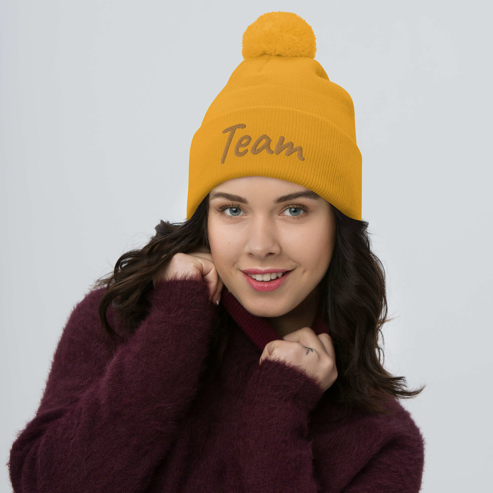 Team In Celluloid Embroidery On Pom Pom Beanie